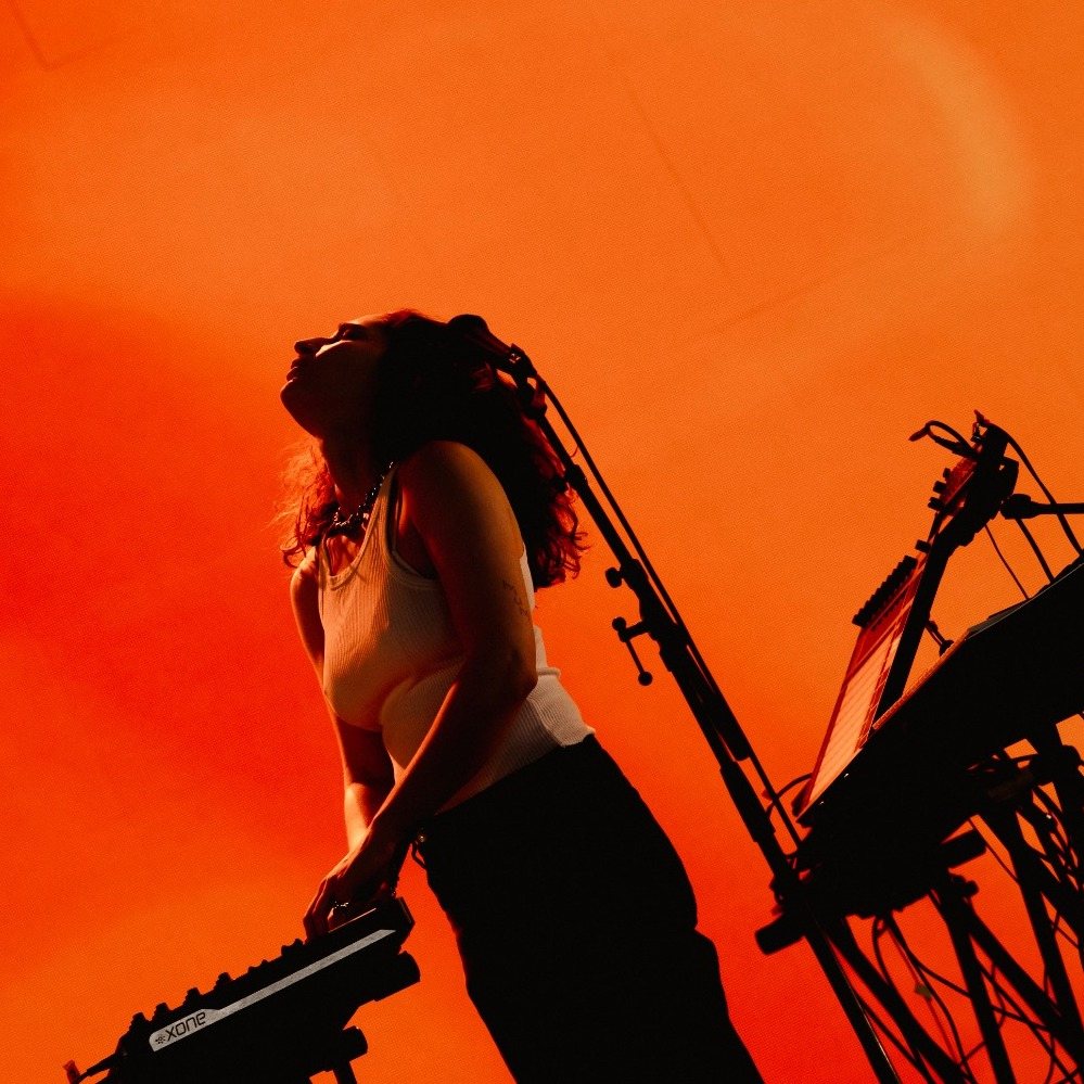 Live performance with orange and red lighting